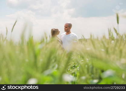 Long shot of a newly married couple at the park