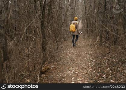 long shot woman hiking with flask