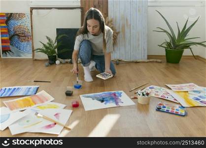 long shot woman painting floor