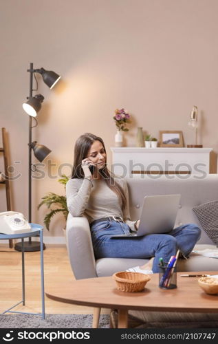 long shot woman sitting couch works