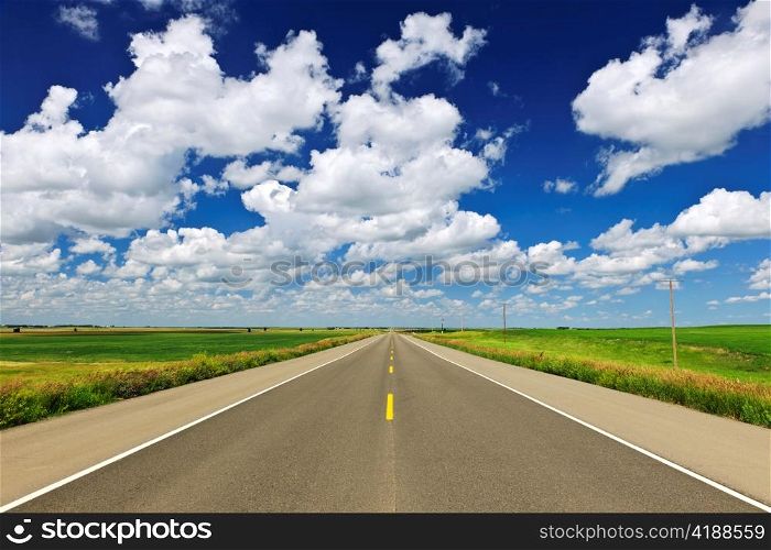 Long stretch of flat highway in Saskatchewan prairies, Canada