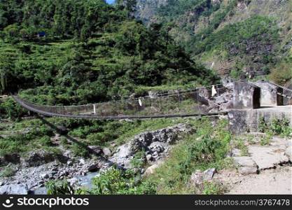Long suspension bridge and river in Nepal