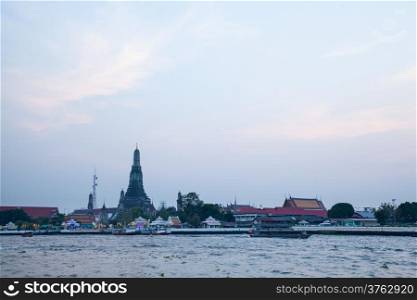 Long tail boat cruising in the river For tourists visiting Thailand. In the background is Wat Arun