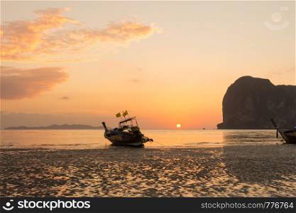 Long tail boat on Pak Meng beach, Trang province, Thailand at sunset