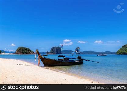 long tail boat tourists on the beach and mountain with blue sky background kra bi Thailand