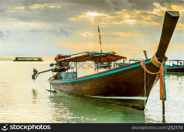 long tailed boat, fishing boat, motor boat with the sunrays