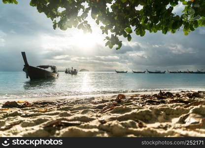 long tailed boat, fishing boat, motor boat with the sunrays