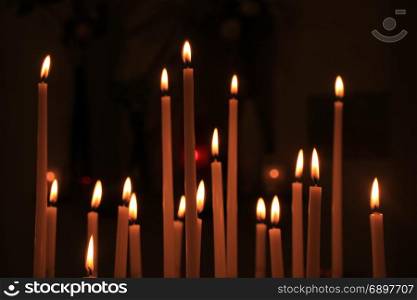 Long thin candles in a roman catholic church