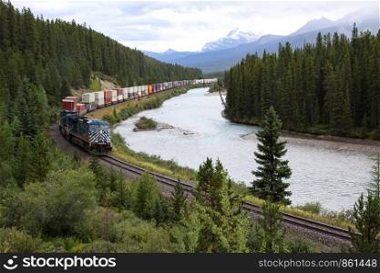 Long train with many cars in Rocky Mountains