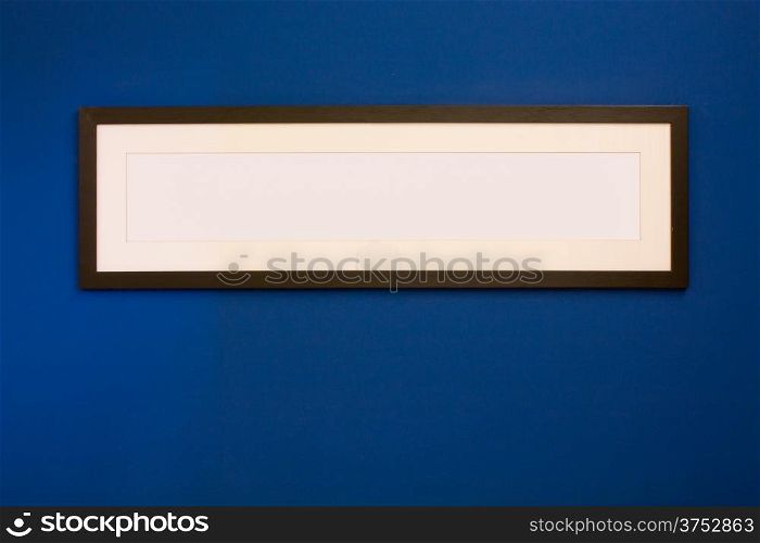 Long Wooden Frame on blue wall.