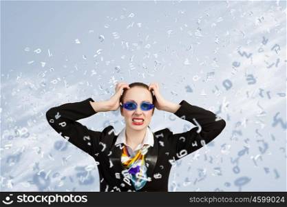Long working hours. Image of irritated businesswoman in goggles with business collage at background