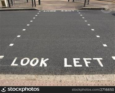 Look Left warning at a pedestrian zebra crossing in a London street. Look left