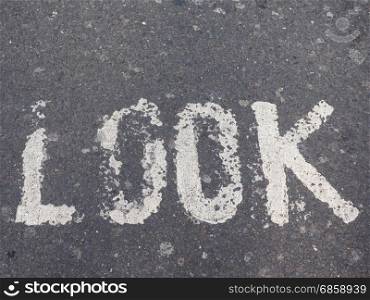 look sign on street. look sign written on street tarmac asphalt