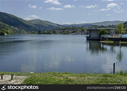 Look toward environment of springtime picturesque dam with mineral baths, resort village Pancharevo in Plana mountain and waterside of Lozen mountain, Sofia, Bulgaria