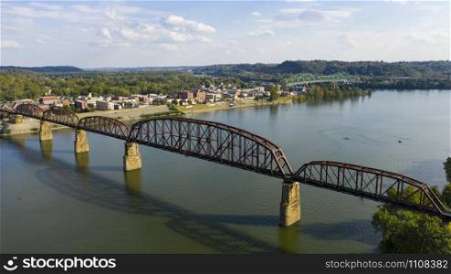 Looking across the Ohio River into downtown Point Pleasant over an old railroad bridge trestle