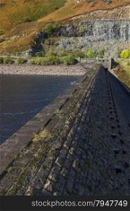 Looking along the top of the dam wall, Caban Coch reservoir, Rhayader, Powys, Wales, United Kingdom, Europe.