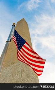 Looking at the Washington Monument from below with the American Flag featured infront