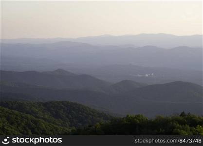 Looking down into the hazy West Virginian valleys during a summer evening where the 100m Green Bank Observatory can be seen about 37 miles away.