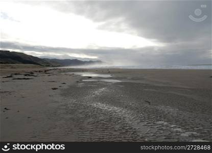 Looking down the sand of Ocean Beach, Hawke&rsquo;s Bay, New Zealand