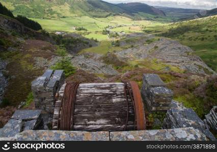 Looking down the welsh valley of Cwm Penmachno, derelict incline drum house disused slate quarry in foreground. Snowdonia, Wales, United Kingdom