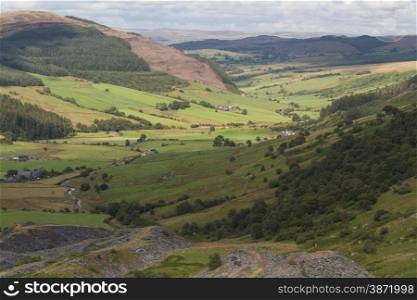 Looking down the welsh valley of Cwm Penmachno, disused slate quarry in foreground. Snowdonia, Wales, United Kingdom
