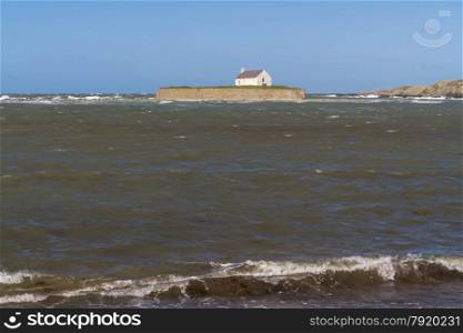 Looking out to see at high tide at St Cwyfan?s Church, the Church in the Sea. Llangwyfan, Aberffraw, Anglesey, Wales, United Kingdom, Europe