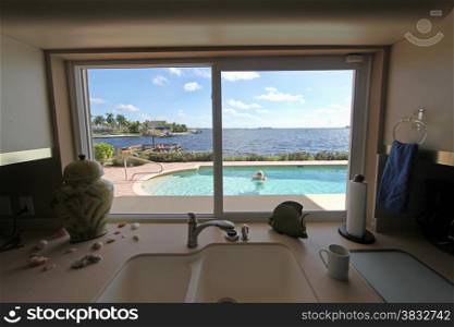 Looking through a window to a pool area with woman in the pool