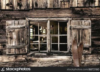 Looking through a wooden window into a rustic farmhouse parlor