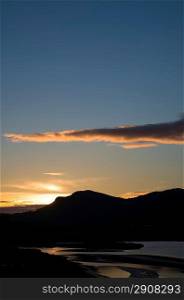 Looking towards Snowdonia mountain range from Porthamdog Cob during Summer sunset