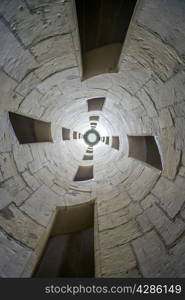 Looking up ancient spiral staircase in church