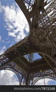 Looking up at the Eiffel tower along one of the four pillars of the famous steel landmark