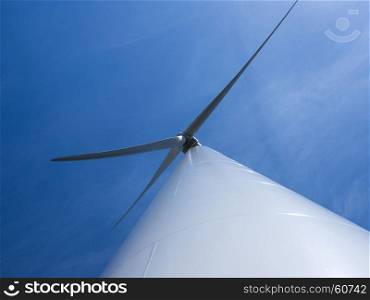 looking up to wind turbine and blue sky