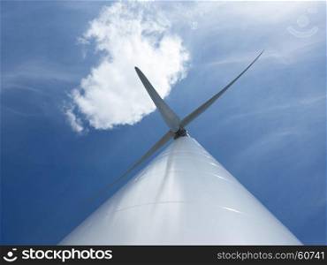 looking up to wind turbine and blue sky with one cloudlooking up to wind turbine and blue sky with one cloud
