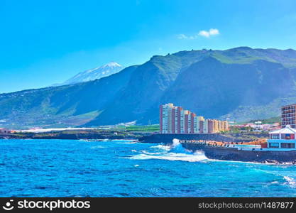 Los Silos town on the north coast of Tenerife and snow-covered Mount Teide in the background, The Canary Islands, Spain