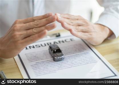 Loss Adjuster Insurance Agent Inspecting Damaged Car. Sales manager giving advice application form document considering mortgage loan offer for car insurance.