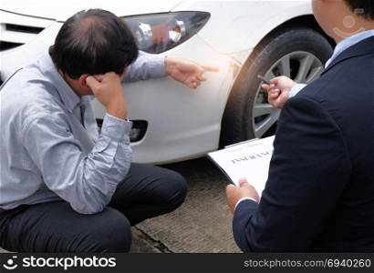 Loss Adjuster Insurance Agent Inspecting Damaged Car selective focus