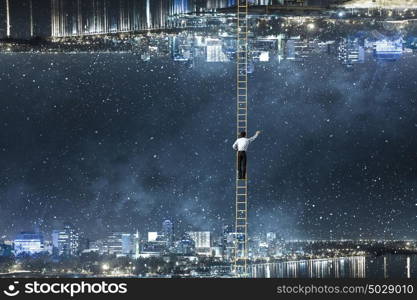 Lost between two worlds. Businessman standing on ladder between two urban realities