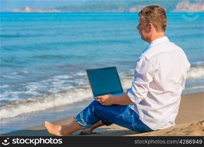 Lost businessman working on a deserted island