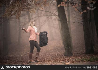 Lost confused woman in foggy fall autumn park searching direction. Fashion young girl holding jacket. Female looking for guidance in forest.. Lost woman foggy autumn park searching direction.