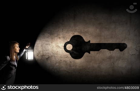 Lost woman. Young pretty businesswoman with lantern in darkness