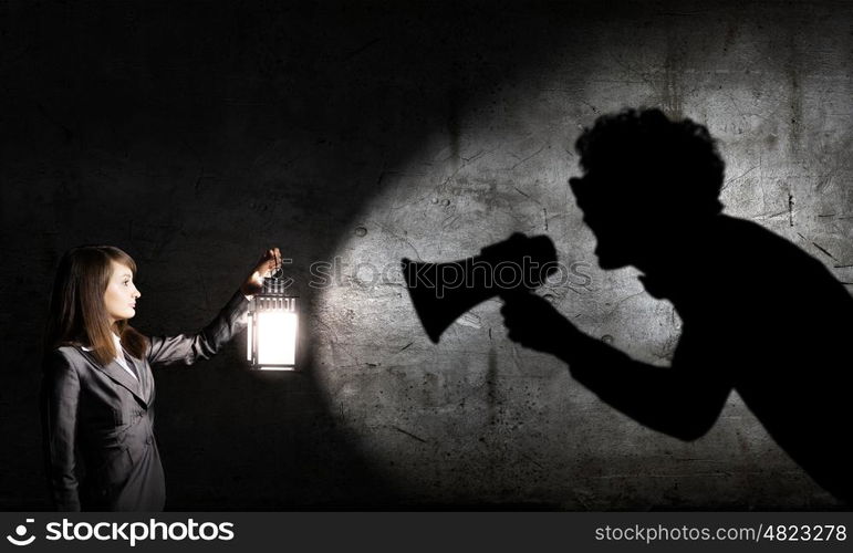 Lost woman. Young pretty businesswoman with lantern in darkness