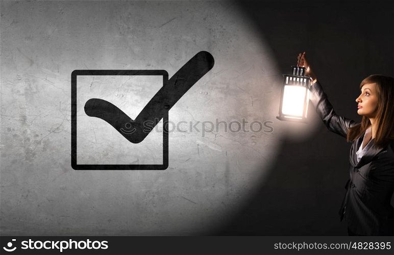 Lost woman. Young pretty businesswoman with lantern in darkness
