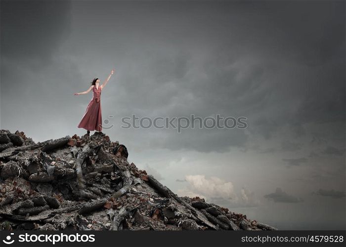 Lost woman. Young woman in evening dress and blindfold standing on mountain top