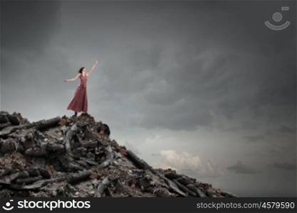 Lost woman. Young woman in evening dress and blindfold standing on mountain top