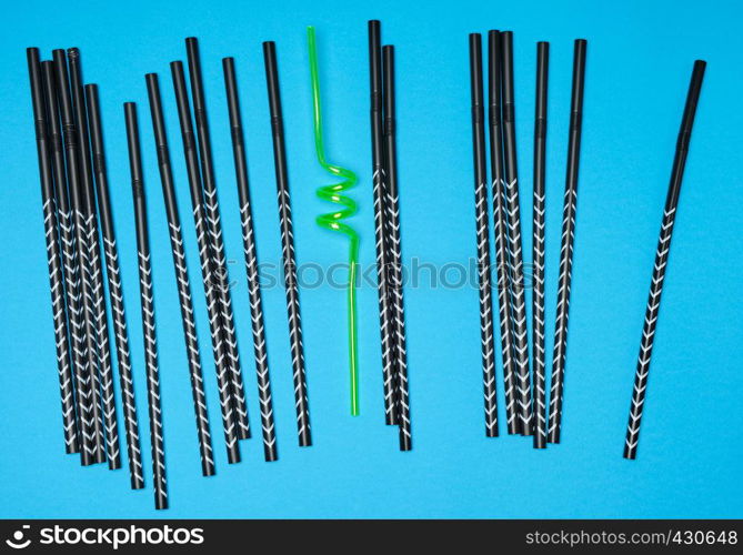 lot of black cocktail tubes and one yellow on a blue background