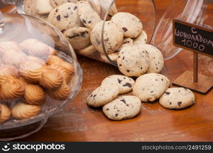 lot of cookies in a vase of glass on the background crumbly biscuits. a lot of cookies in a vase of glass