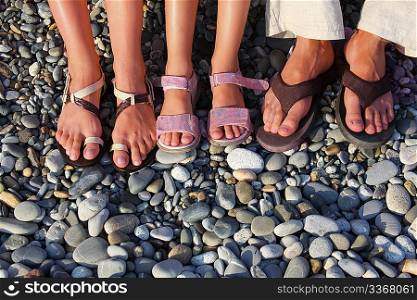 lot of feet on the stones. family with girl