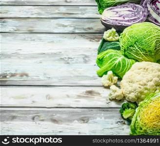 Lot of fresh juicy cabbage. On a wooden background.. Lot of fresh juicy cabbage.