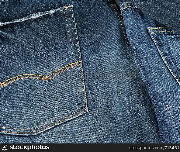 Lots of blue classic jeans stacked chaotically, back pocket
