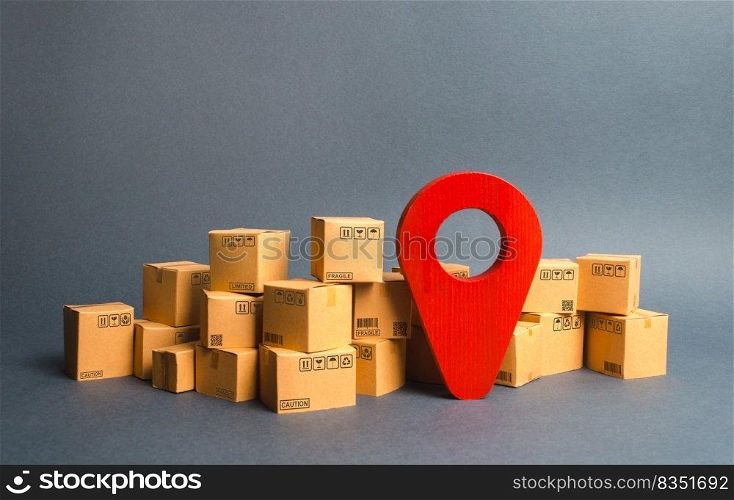 Lots of cardboard boxes and a red position pin. Locating packages and goods. Algorithm for constructing a minimum route for the delivery of orders. Logistics transportation, storage warehouse.
